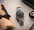 Tudor Black Bay 54 flat-lay with loupe and canvas pouch