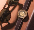 Chopard L.U.C Qualité Fleurier 20th Anniversary Edition flat-lay with sunglasses and phone case