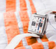 TAG Heuer Monaco Chronograph × Gulf propped up on top of racing suit