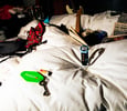Swatch Broken Rules on bed in trashed hotel suite