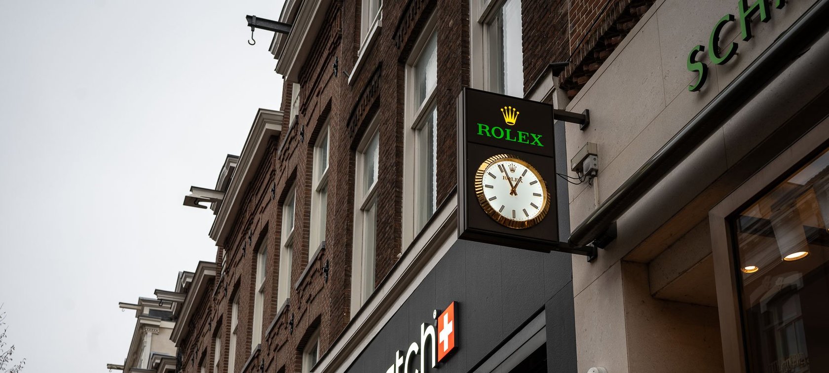 watch branding — Rolex clock and Swatch boutique
