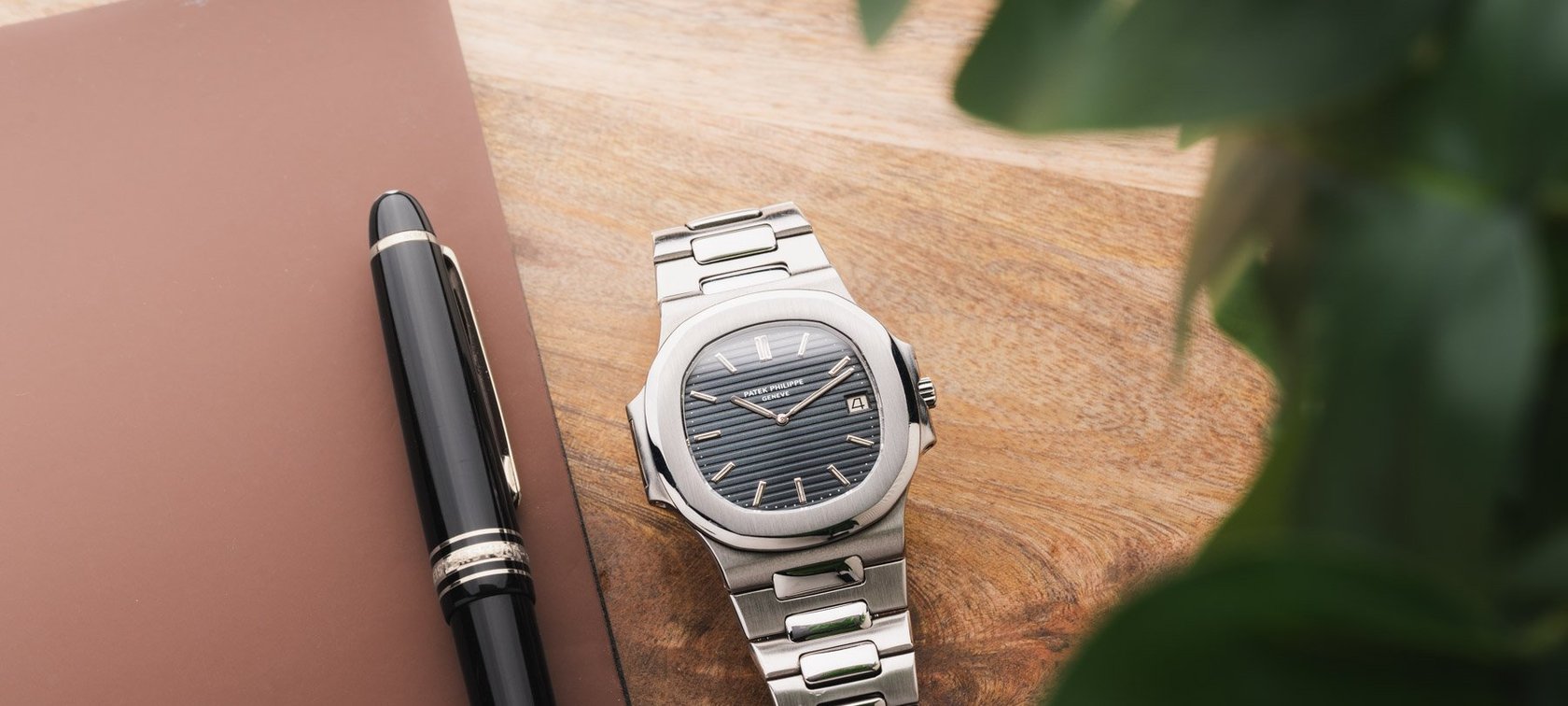 Patek Philippe Nautilus flat-lay with pen
