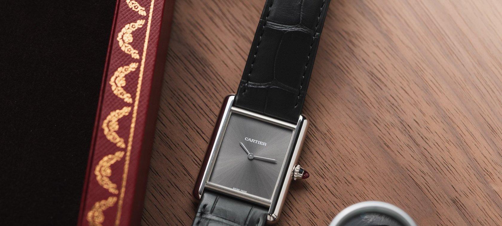 platinum Cartier Tank Must flat-lay with loupe
