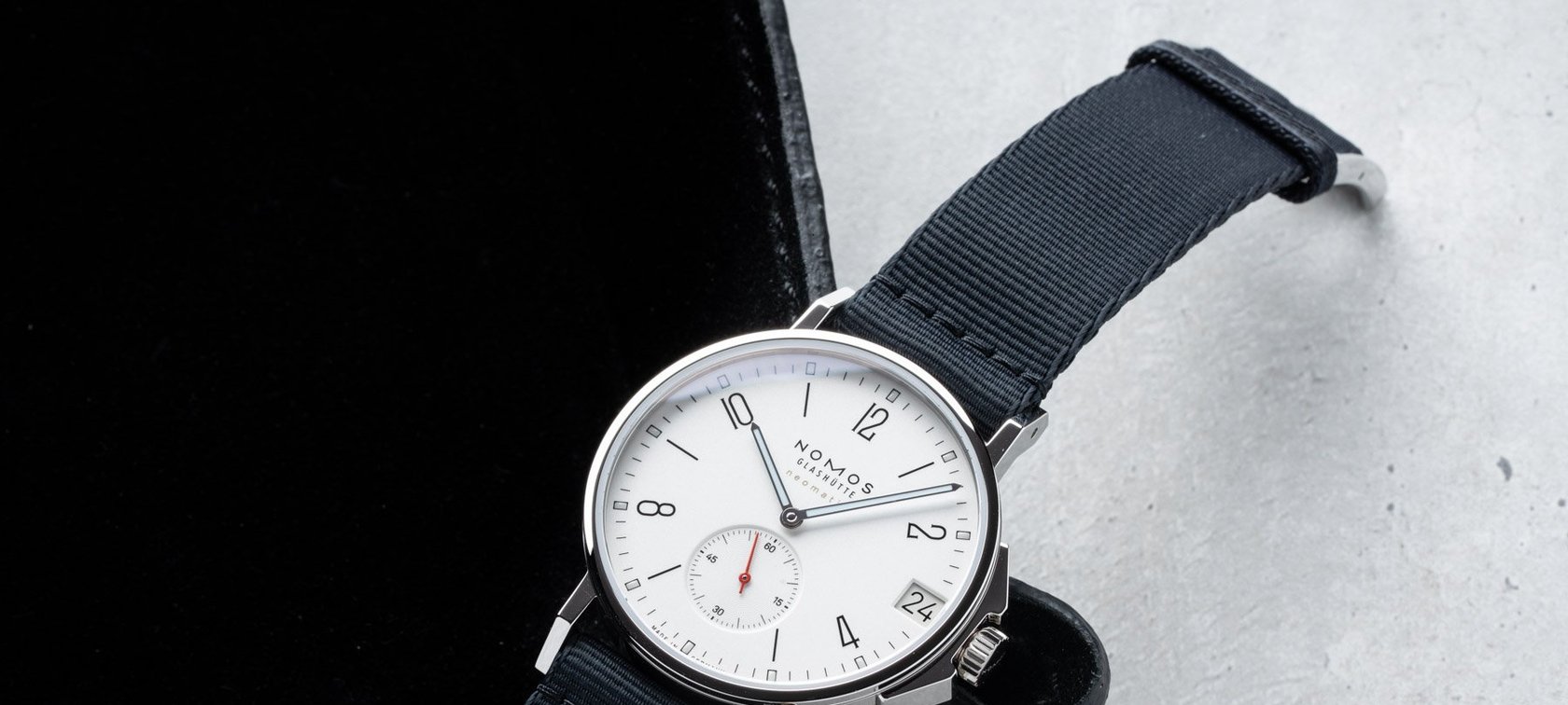 white-dial Ahoi Neomatik 38 Date on corner of black watch tray