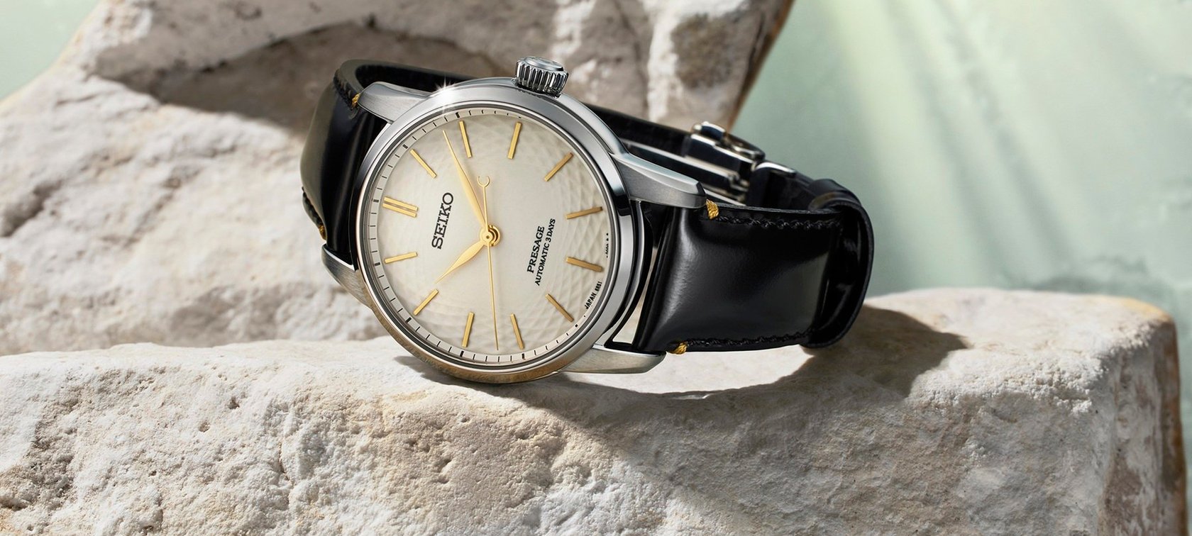 Seiko Presage Classic Series Craftsmanship Unglazed Arita Porcelain Dial Limited Edition SPB497 on rock, crown up