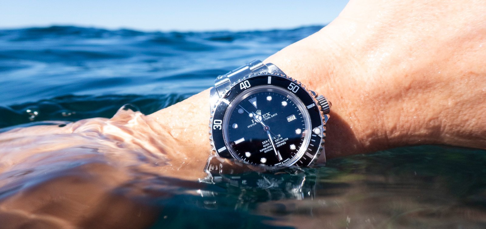 Rolex Sea-Dweller 16600 wrist shot on surface of water