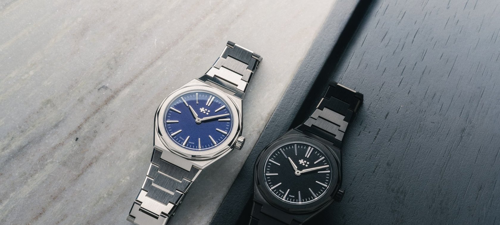 blue- and black-dial Christopher Ward Twelve 660 models side by side
