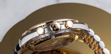 steel and Moonshine Gold Omega Speedmaster Professional Moonwatch case side, crown, and pushers