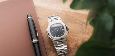 Patek Philippe Nautilus flat-lay with pen