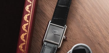 platinum Cartier Tank Must flat-lay with loupe