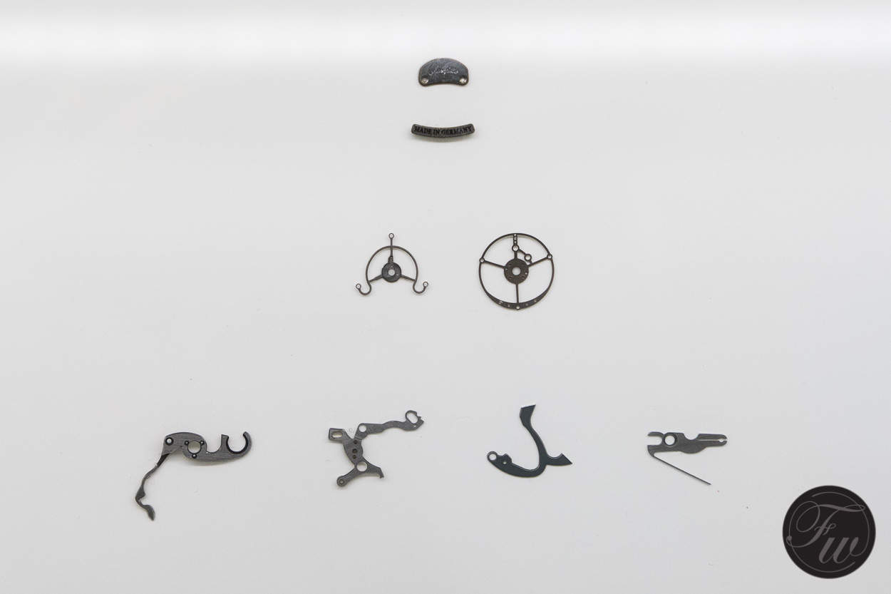 Tiny parts are being cut - or actually burnt - from brass and steel strips.