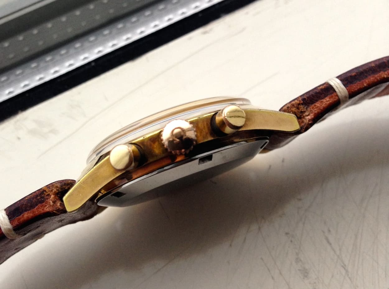 A signed crown that certainly is showing some patina.