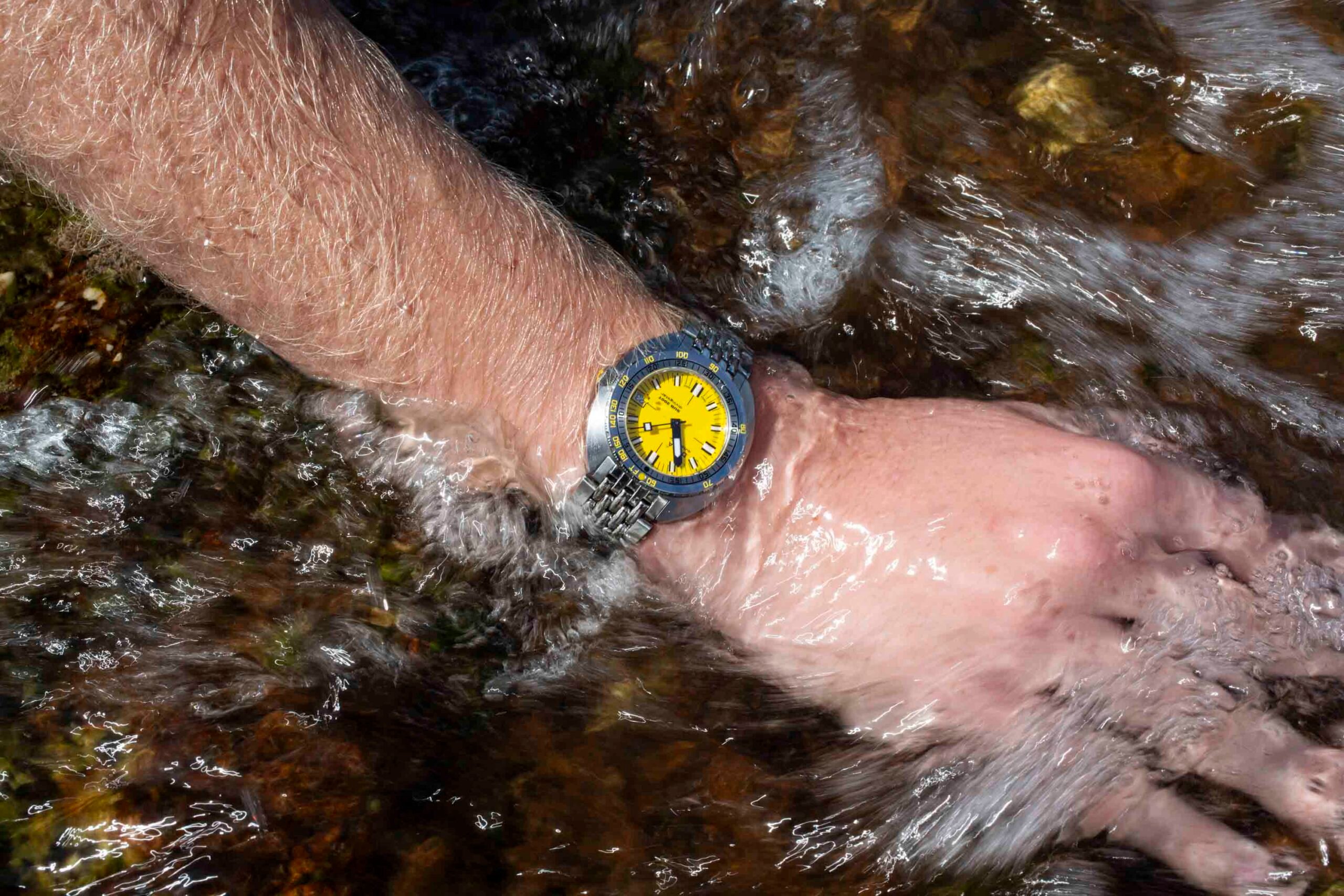 Doxa Sub 300T Divingstar on wrist, hand in running water
