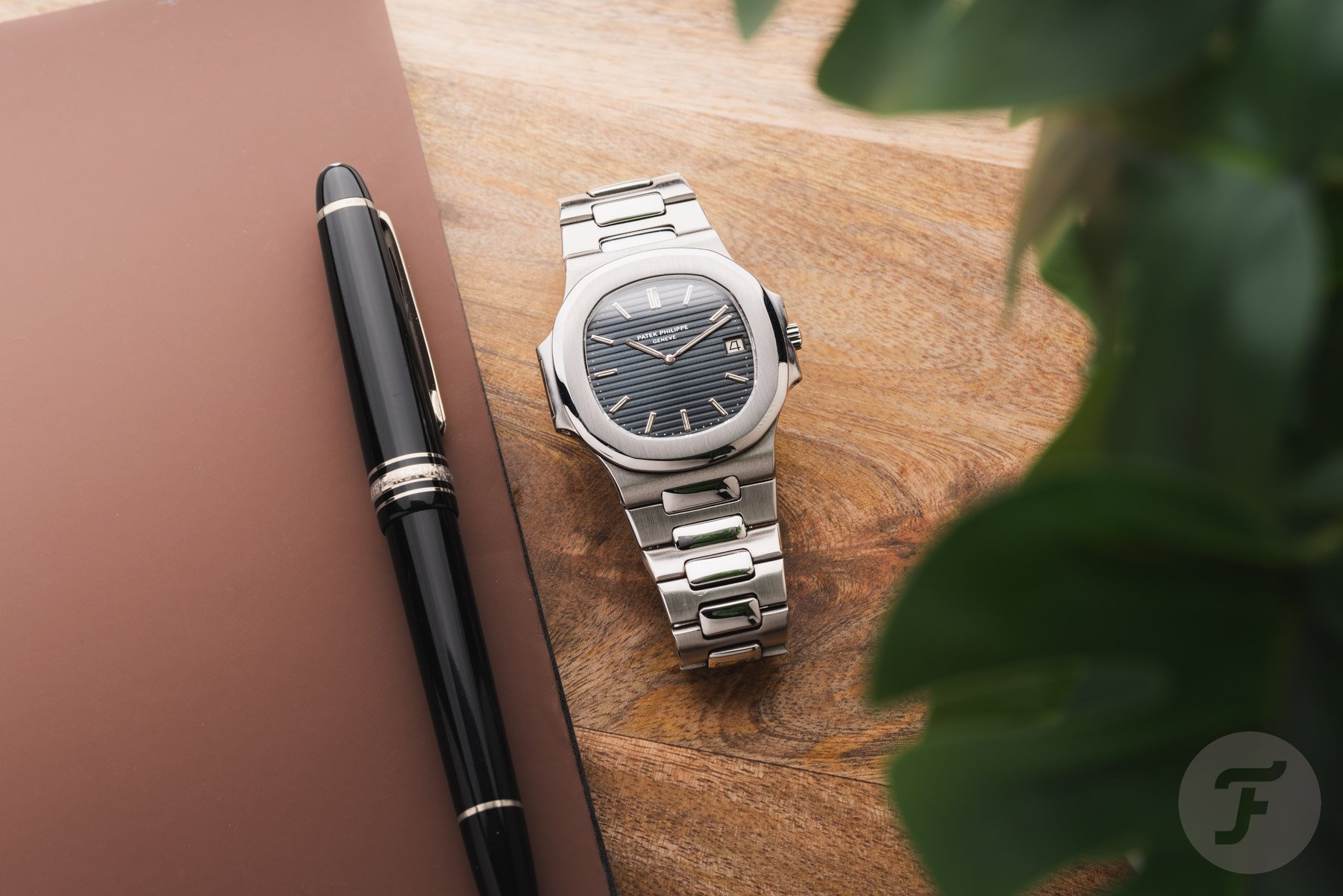 Patek Philippe Nautilus flat-lay with pen
