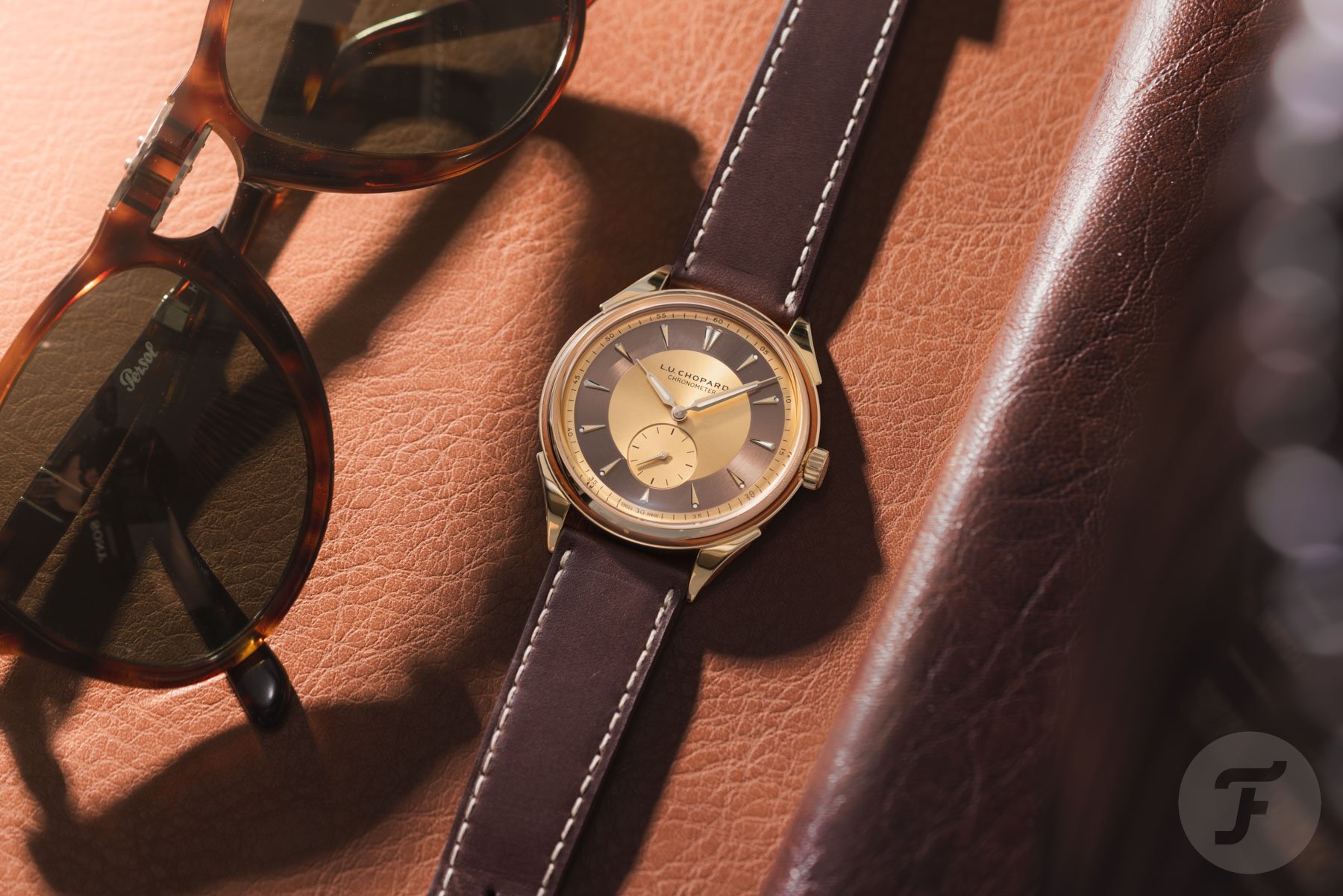 Chopard L.U.C Qualité Fleurier 20th Anniversary Edition flat-lay with sunglasses and phone case