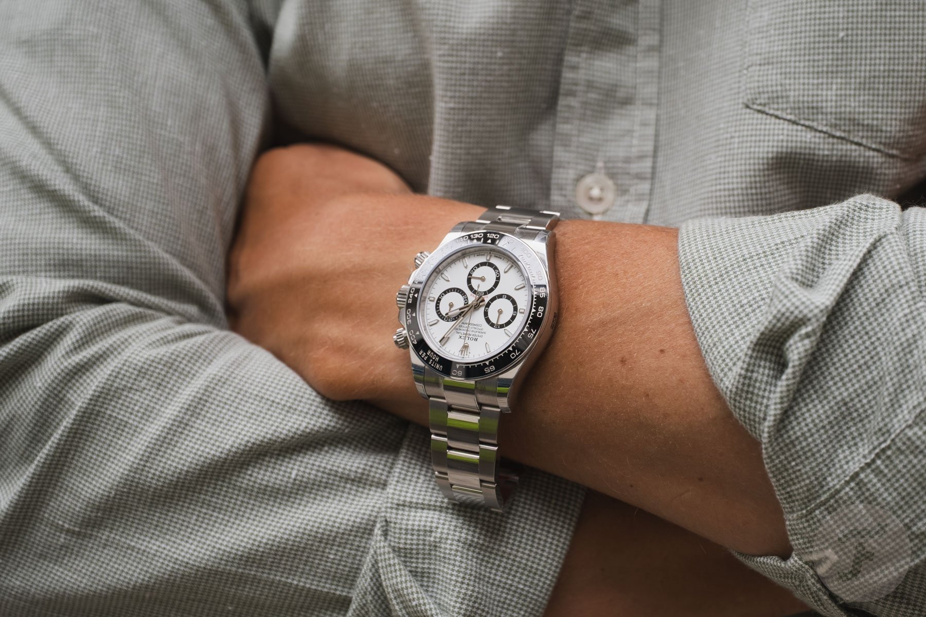 Rolex Cosmograph Daytona ref. 126500LN-0001 on wrist, arm crossed