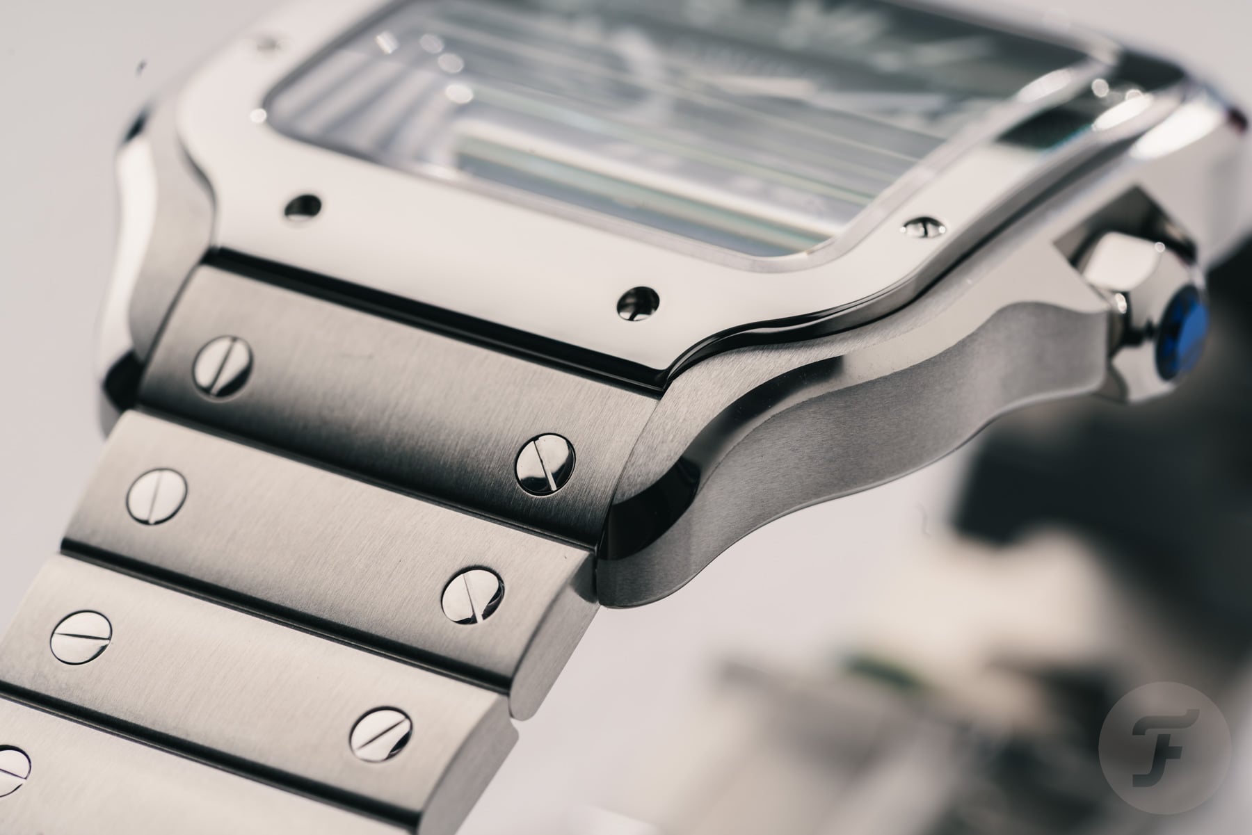 black-dial steel Cartier Santos lug and bezel detail