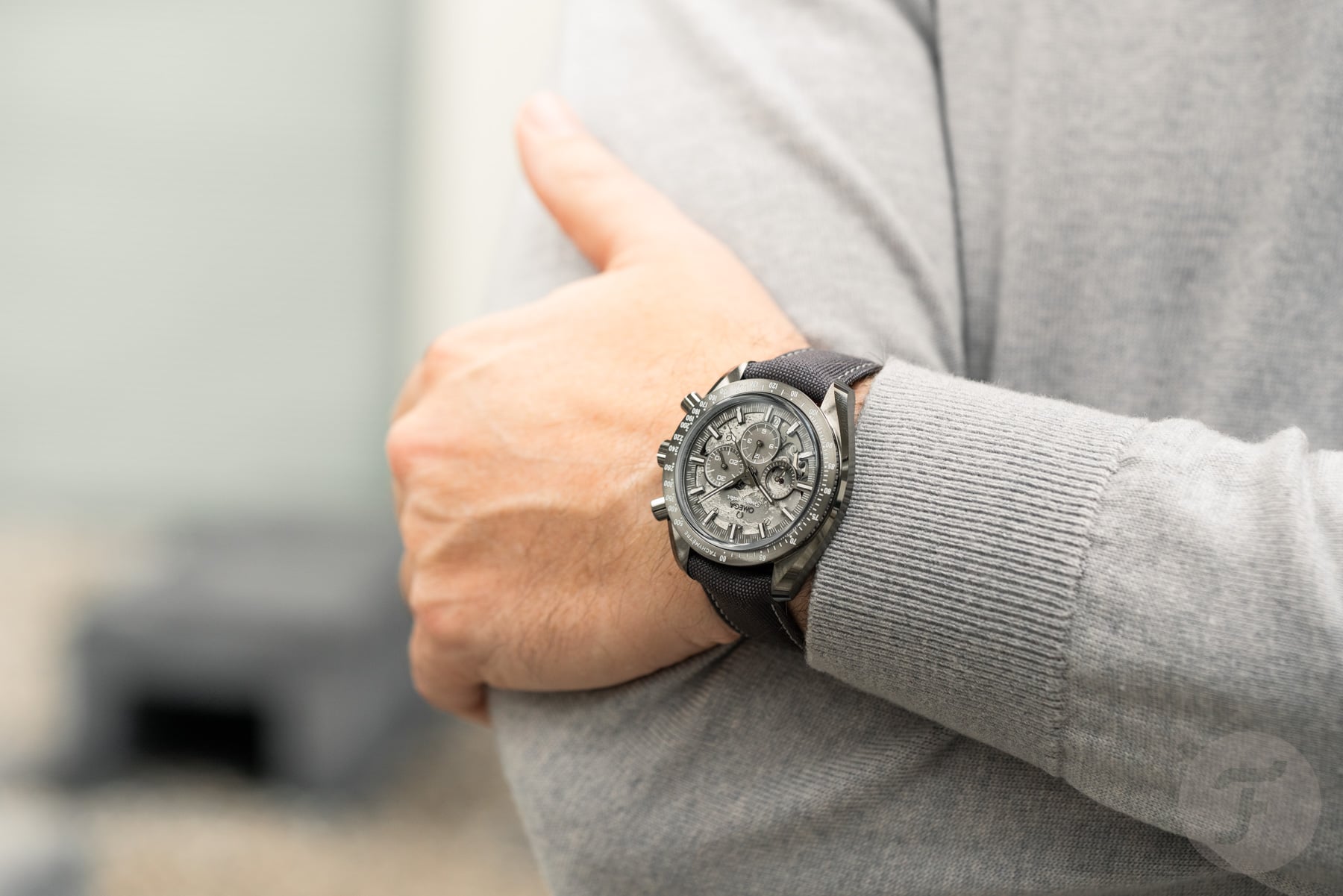 best watches of 2025 — Omega Speedmaster Grey Side of the Moon on wrist, arms crossed