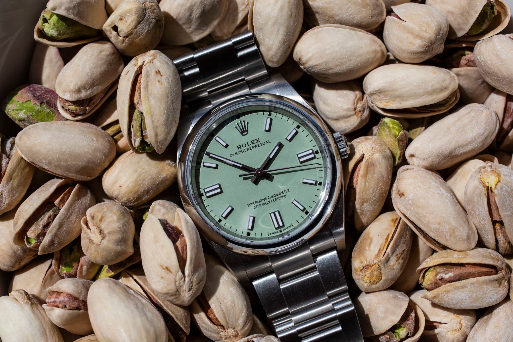 Rolex Oyster Perpetual 36 flat-lay on pistachios