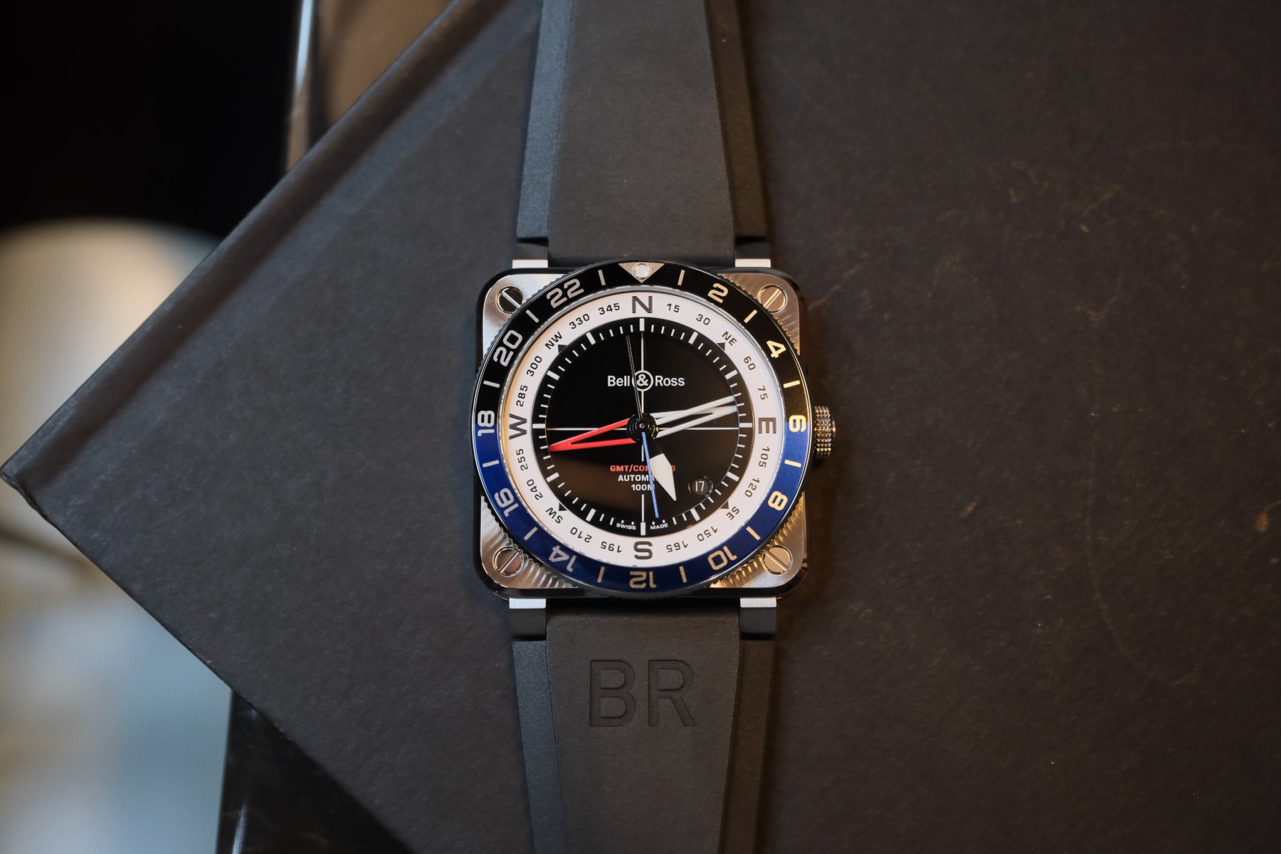 Bell & Ross BR-03 GMT Compass flat-lay on book