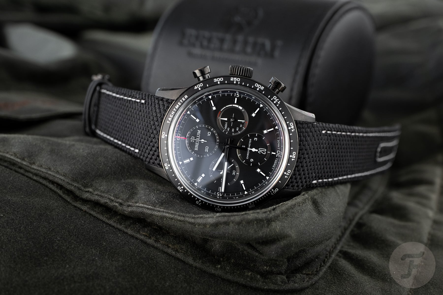 Pandial Power Reserve Black Titanium LE Chronometer on side, crown up, with branded travel case in background