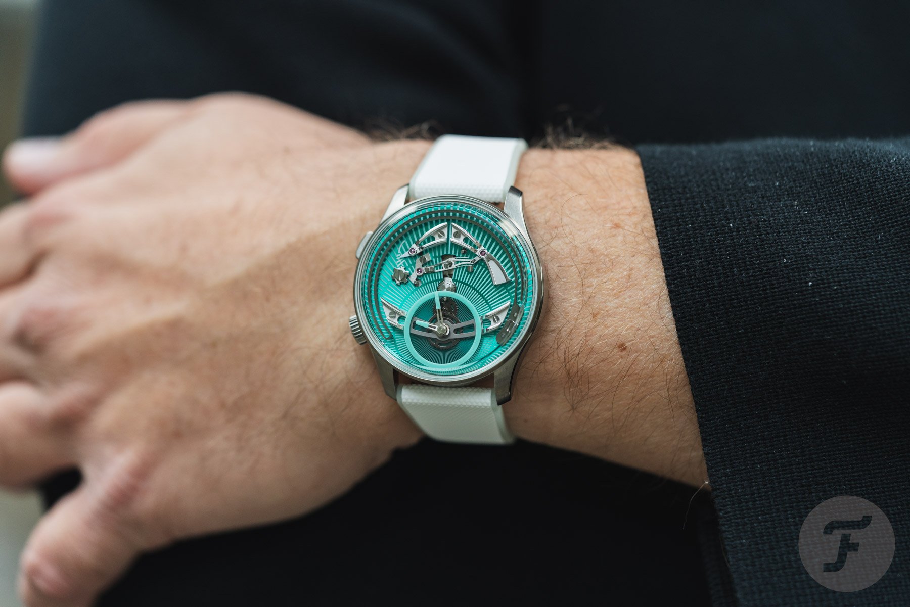 Christopher Ward C1 Bel Canto Lumière on wrist, arms crossed