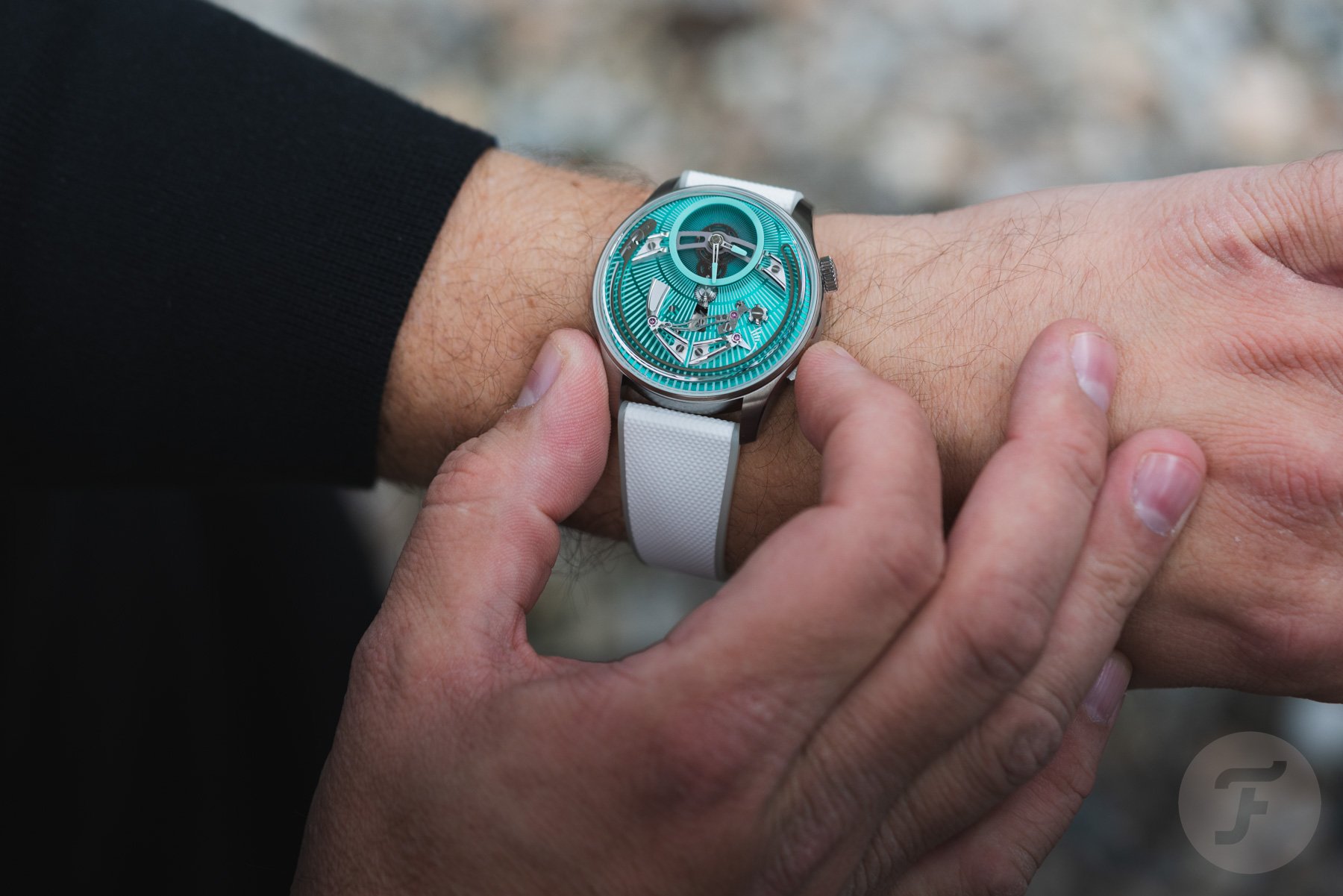 operating the Christopher Ward C1 Bel Canto Lumière on wrist