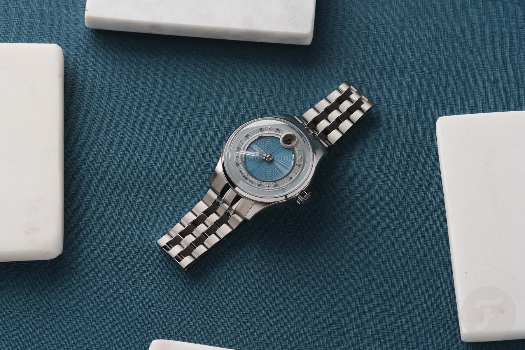 Christopher Ward C1 Jump Hour Mk V flat-lay with white marble squares