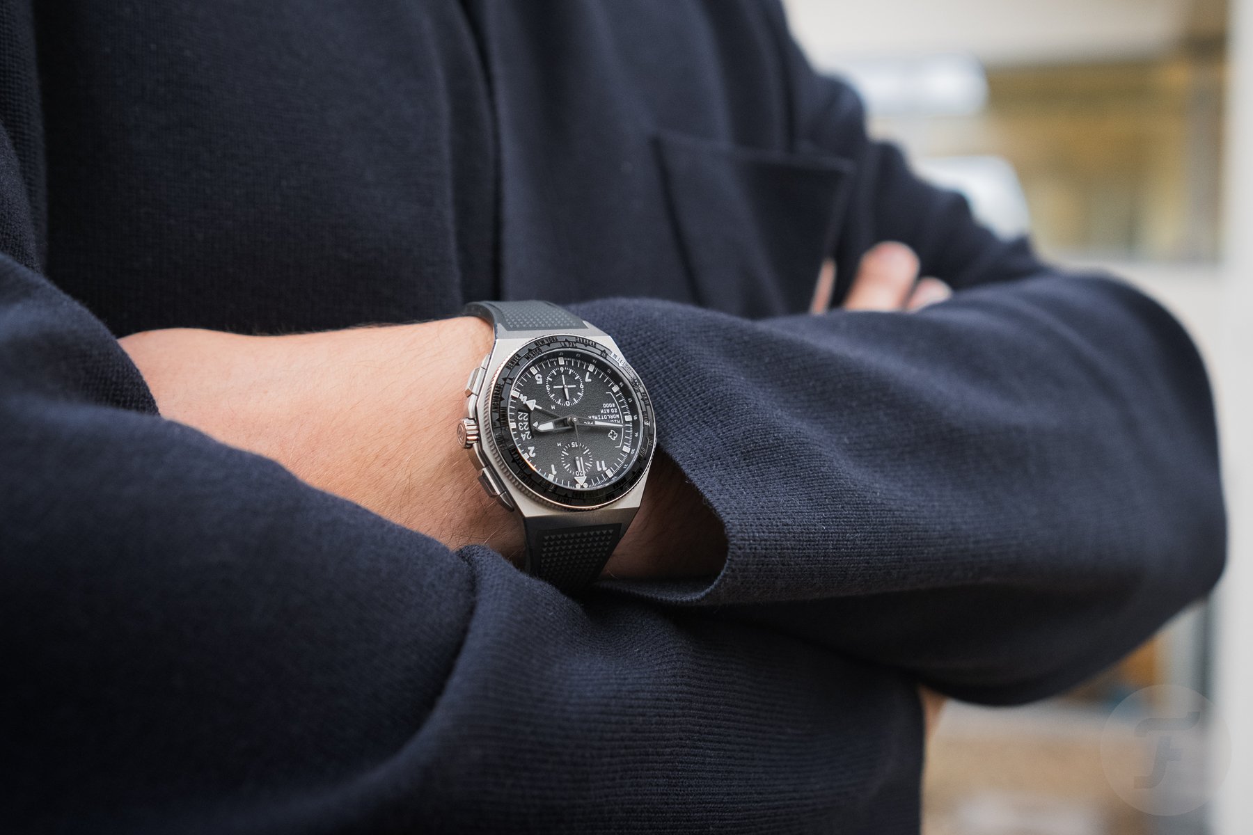 Micromilspec Worldtimer on wrist, arms crossed