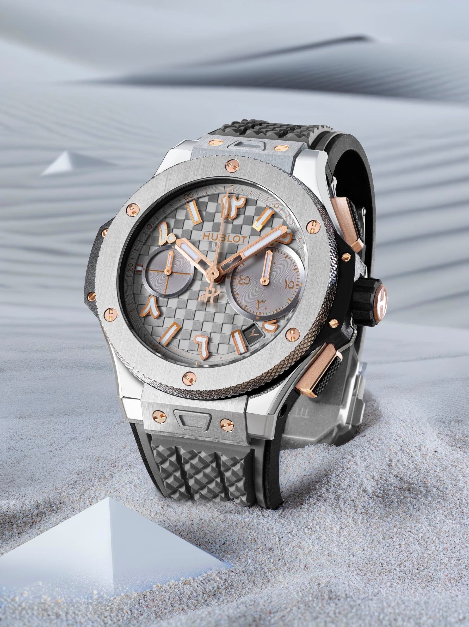 Hublot Big Bang Ahmed Seddiqi 75th Anniversary Titanium Grey upright in sand