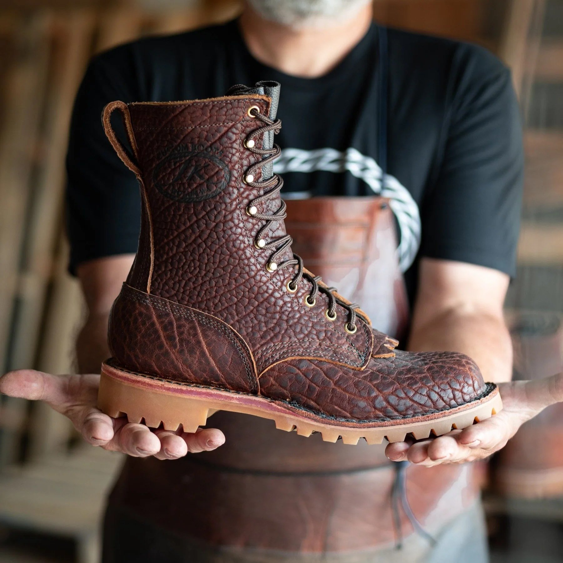 man holding JK Boots O.T. Bison boots