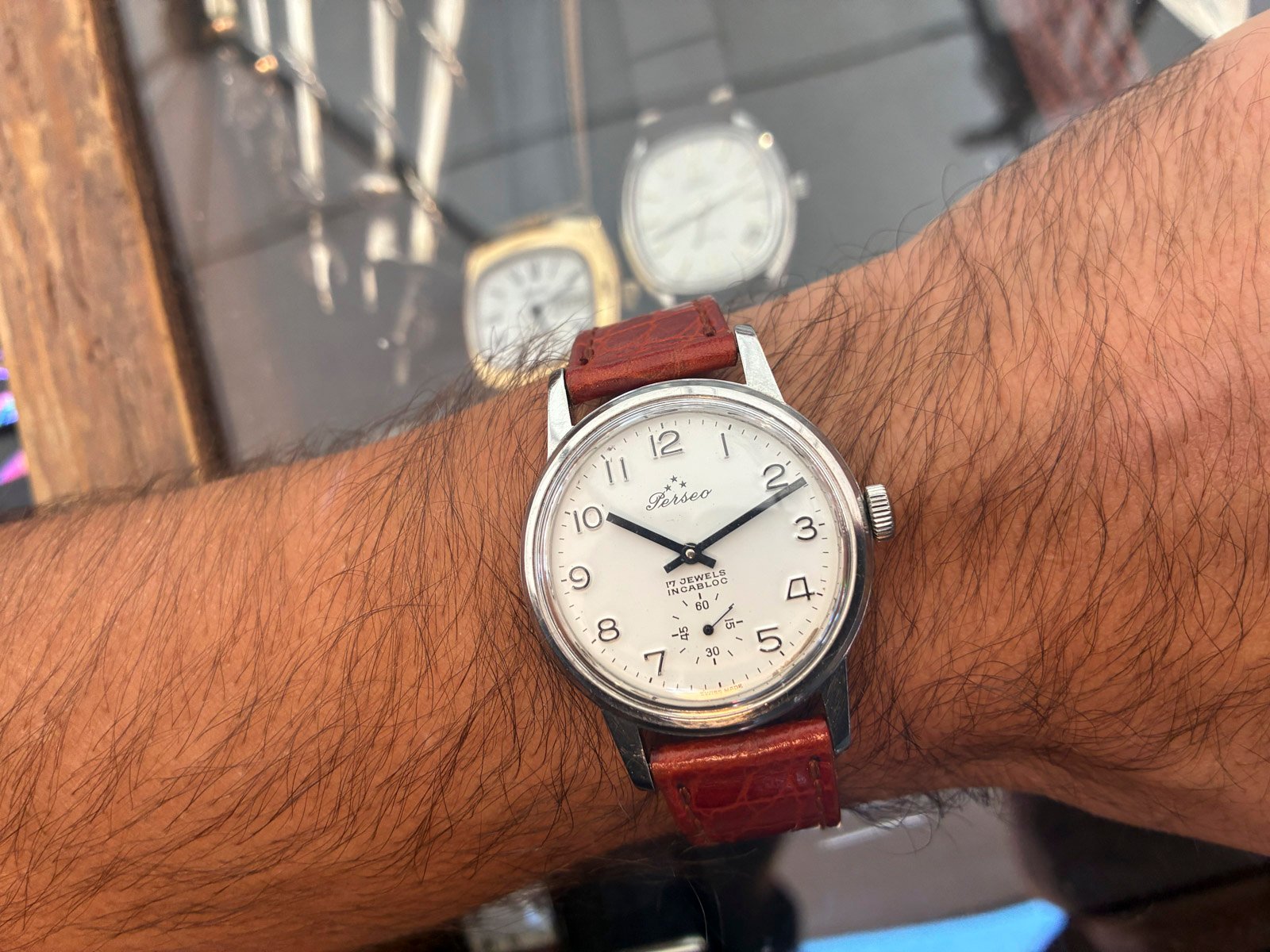 wrist shot of round Perso FS watch in flea market