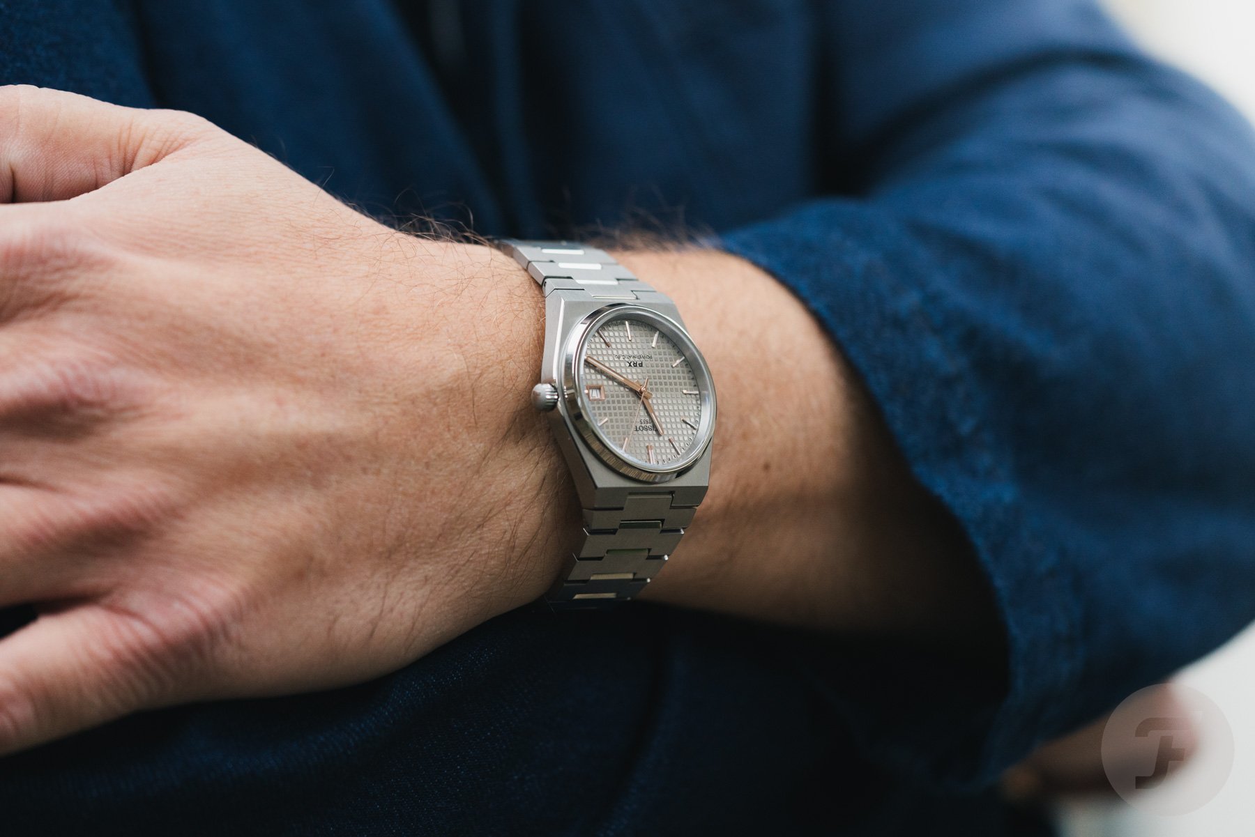 Tissot PRX Titanium 38mm on wrist, arms crossed