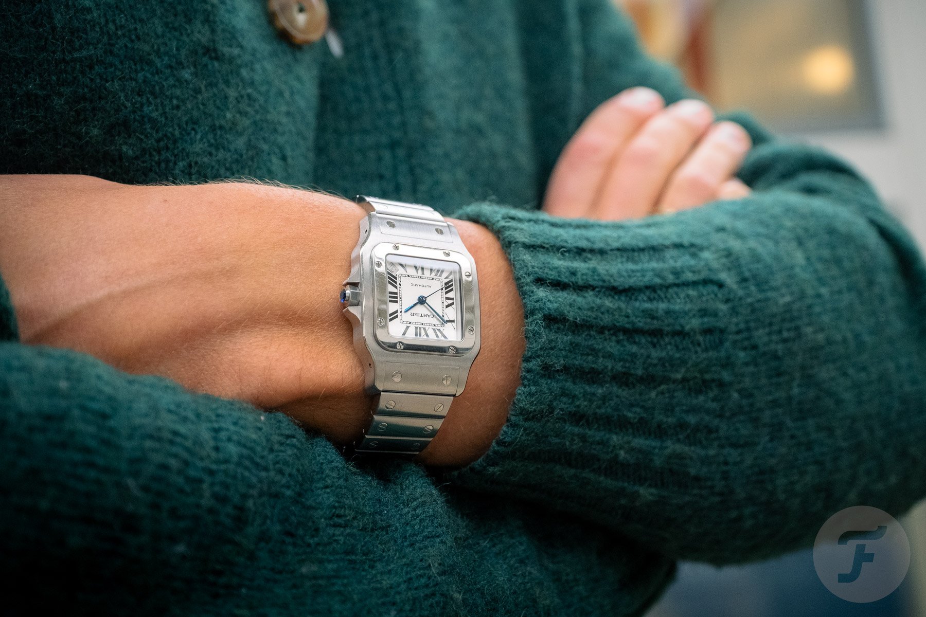 Cartier Santos Galbée XL on wrist, arms crossed