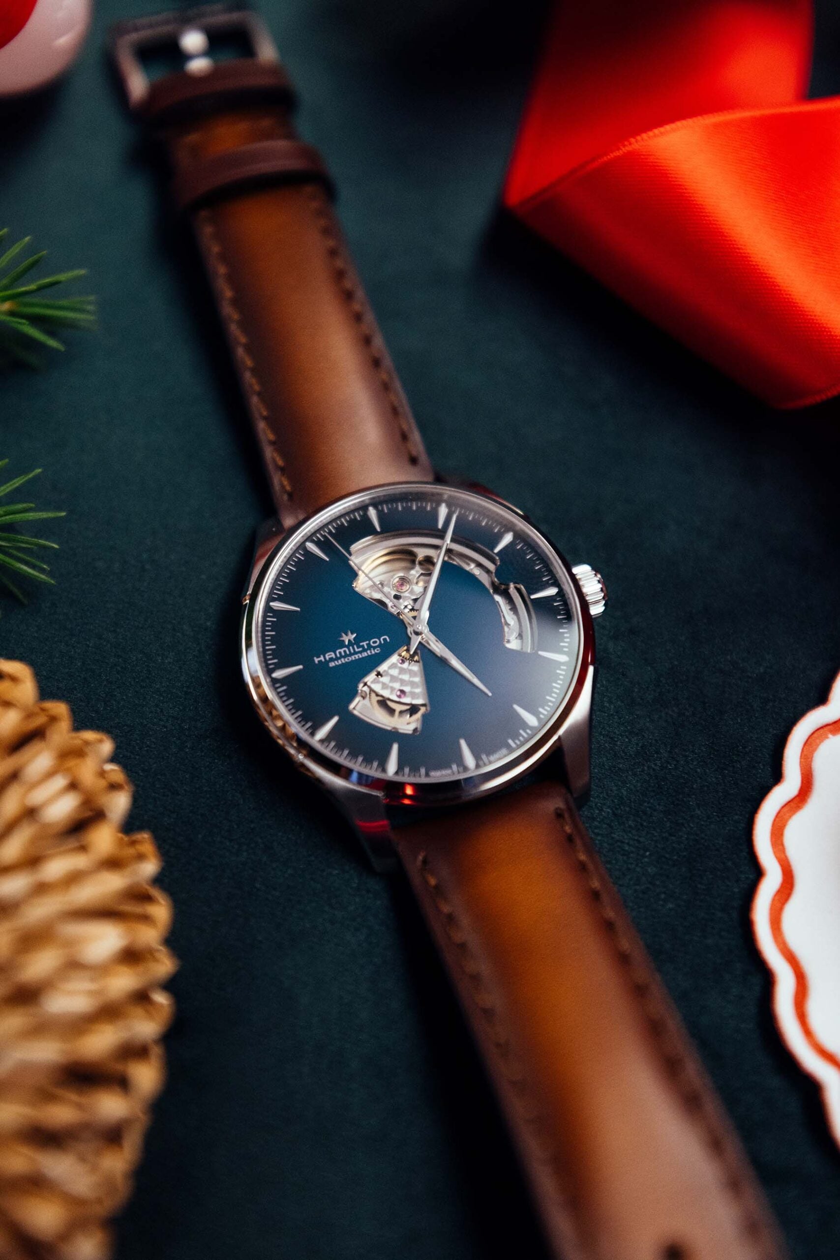 Hamilton Jazzmaster Open Heart holiday flat-lay