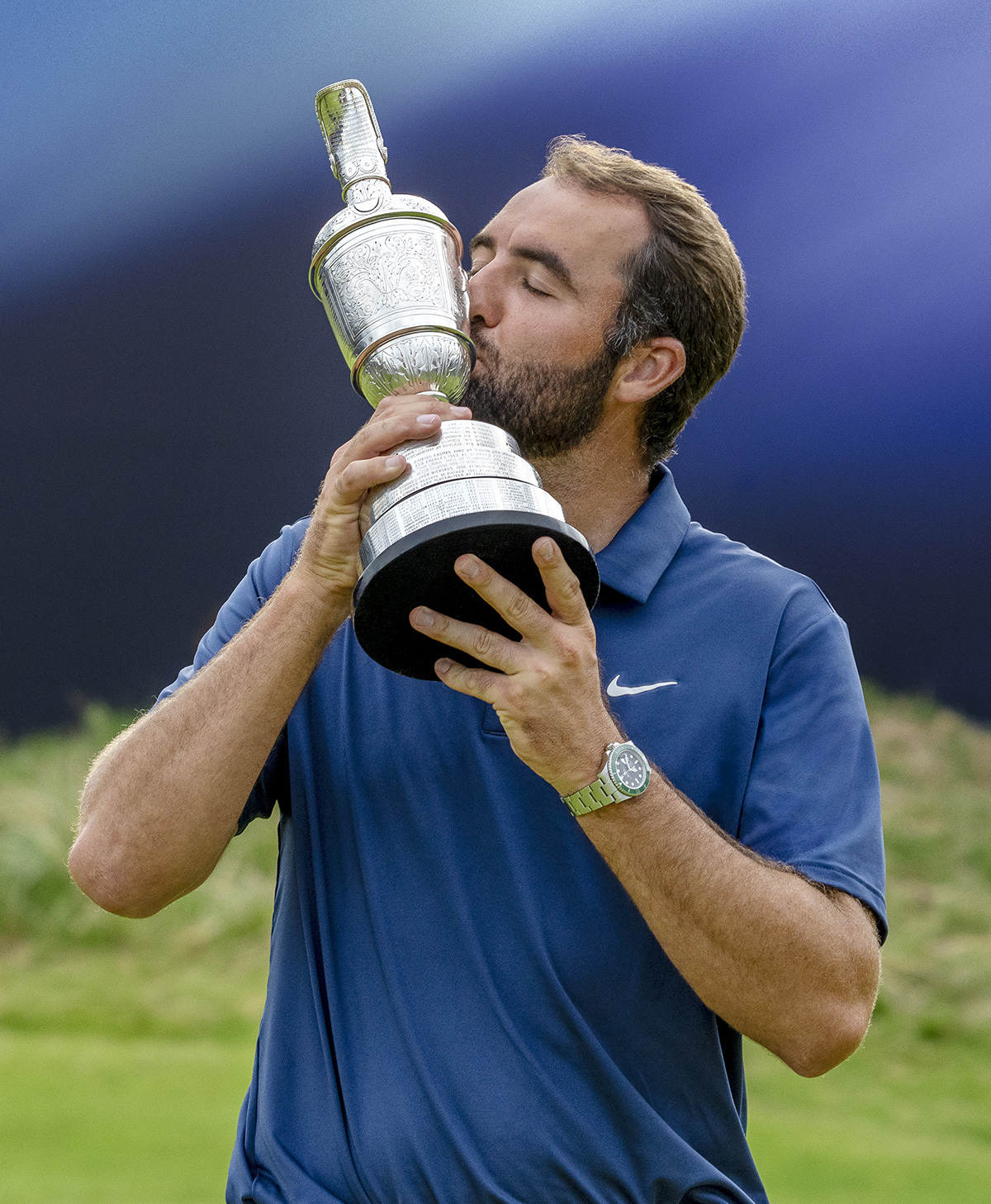 watches on the podium in 2025 — The Open winner Scottie Scheffler kissing the trophy with a Rolex on his wrist