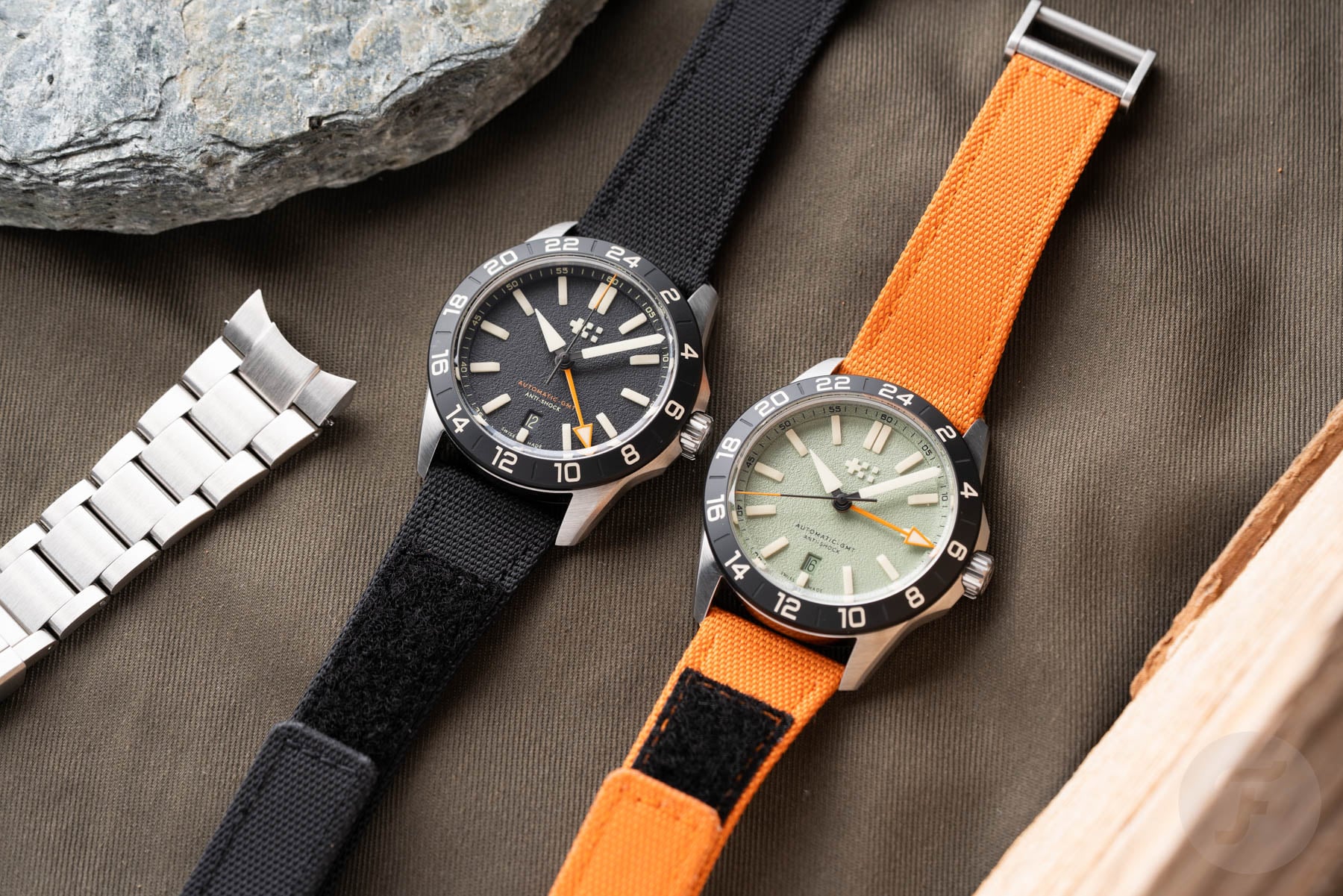 black- and green--dial Christopher Ward C63 Sealander Extreme GMT models side by side, flat-lay