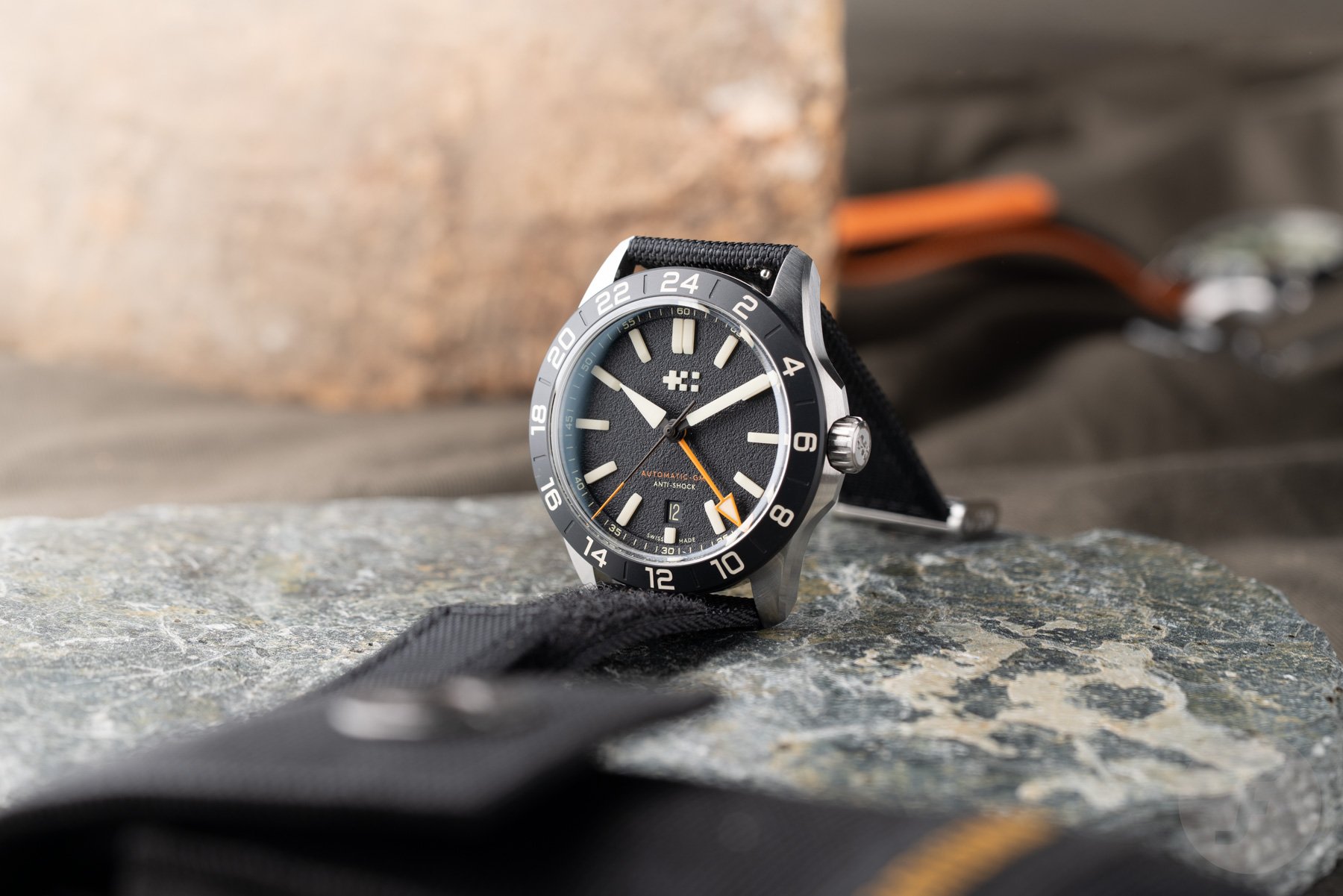 black-dial Christopher Ward C63 Sealander Extreme GMT propped up on black V-Strap