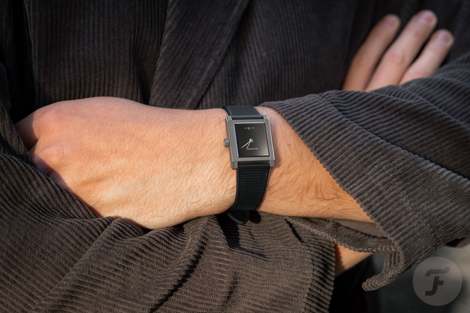 Echo/Neutra Rivanera Piccolo on wrist, arms crossed