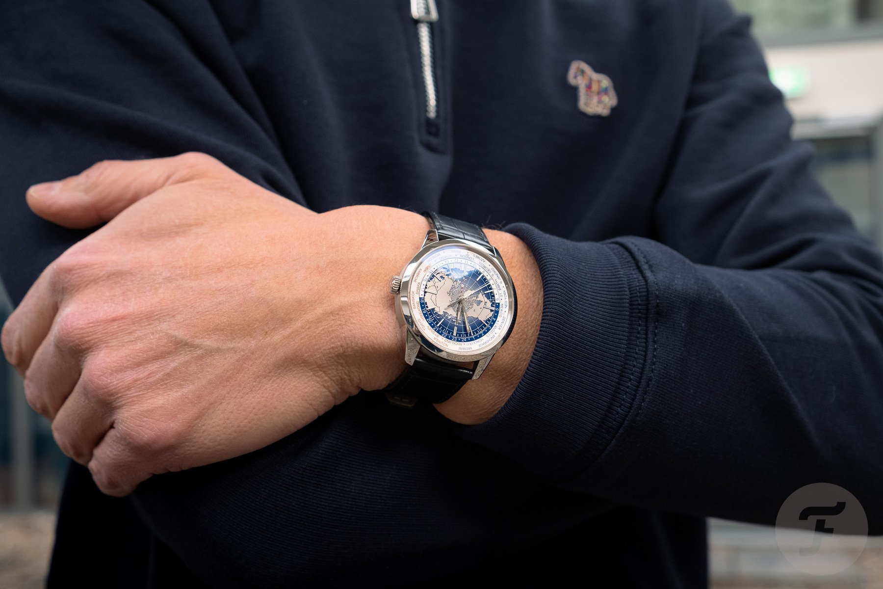 Jaeger-LeCoultre Geophysic Universal Time on wrist, arms crossed