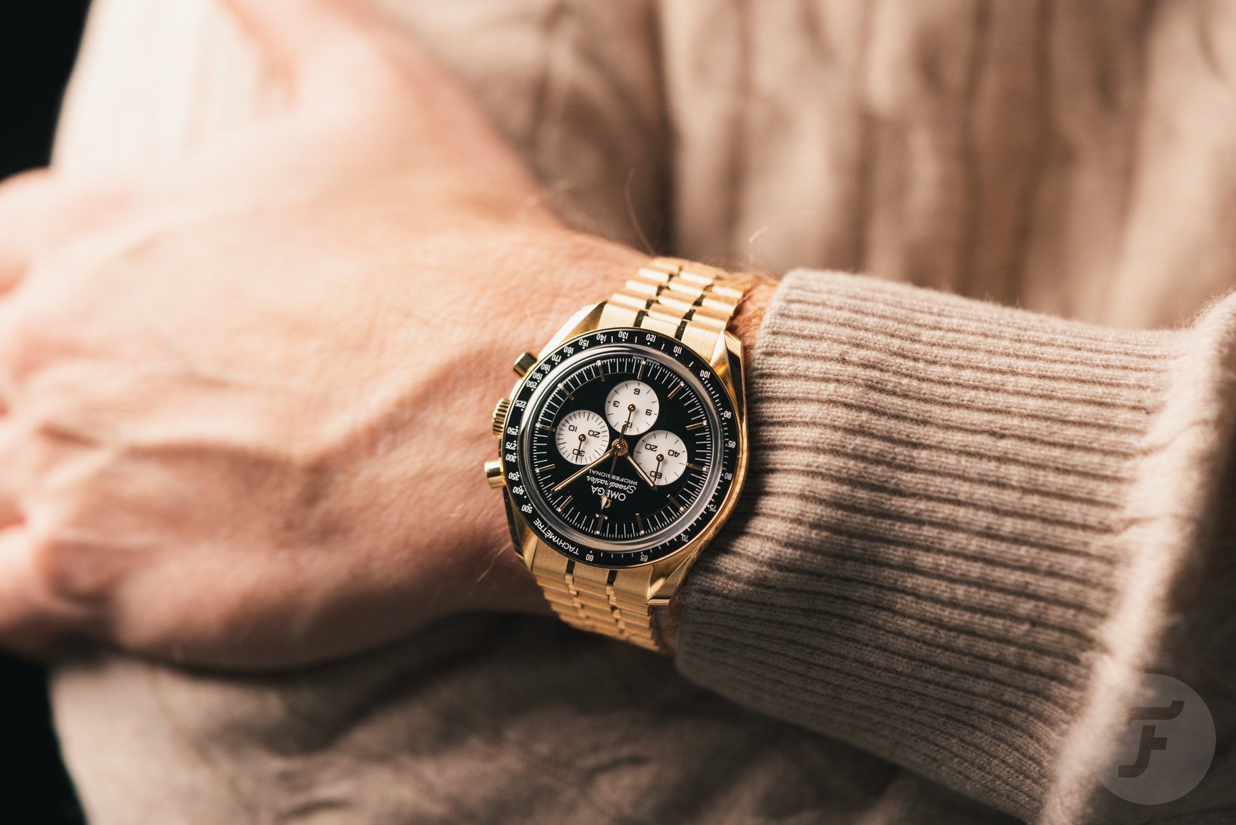 Omega Speedmaster Moonwatch Professional "Reverse Panda" ref. 310.60.42.50.01.002 on wrist, arms crossed