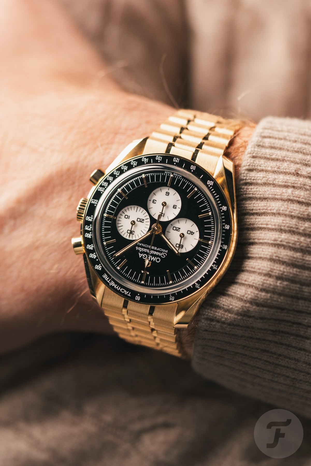 Omega Speedmaster Moonwatch Professional "Reverse Panda" ref. 310.60.42.50.01.002 on wrist, arms crossed