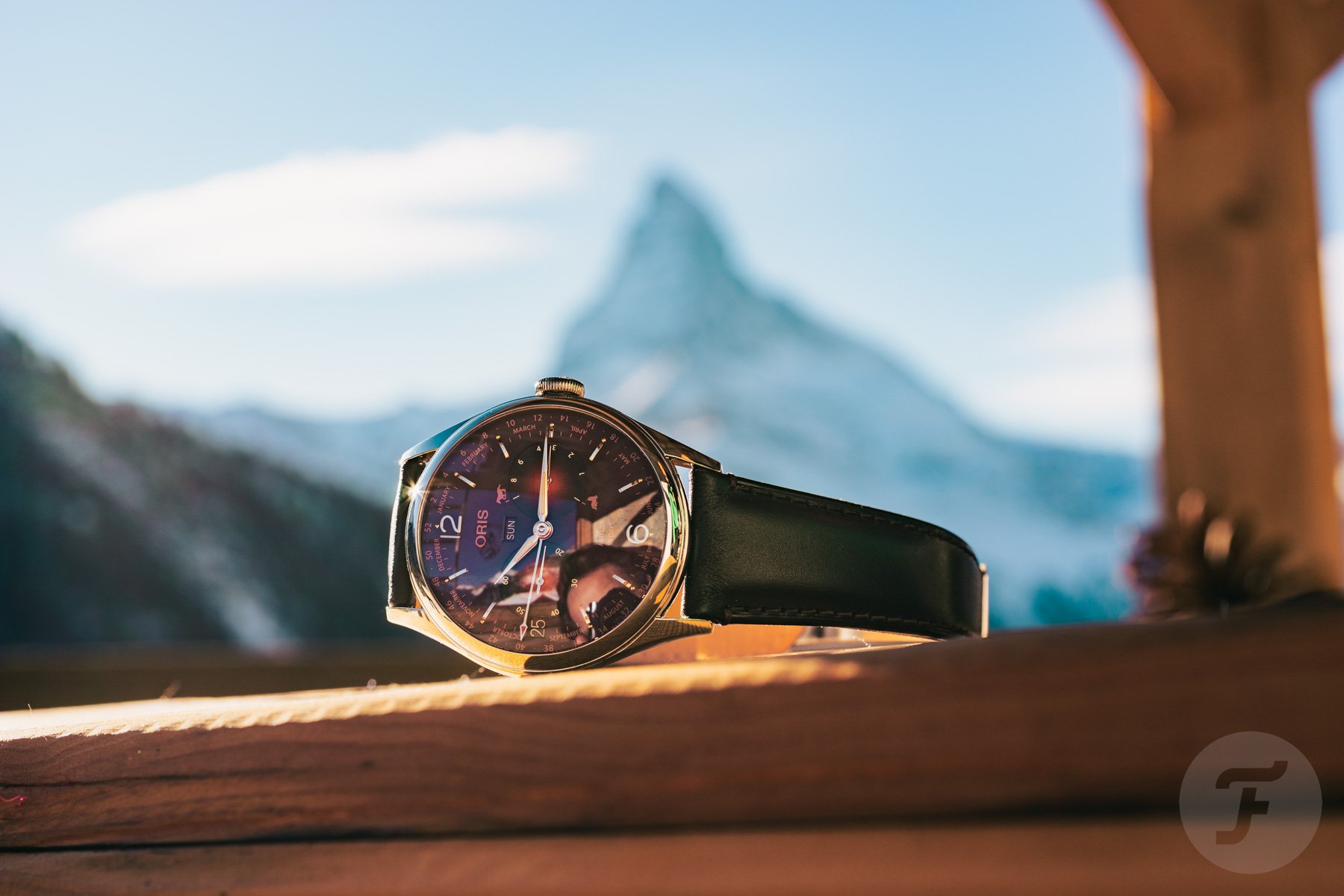 Oris Artelier Year Of The Horse Limited Edition on its side, crown up, with the Matterhorn in the background