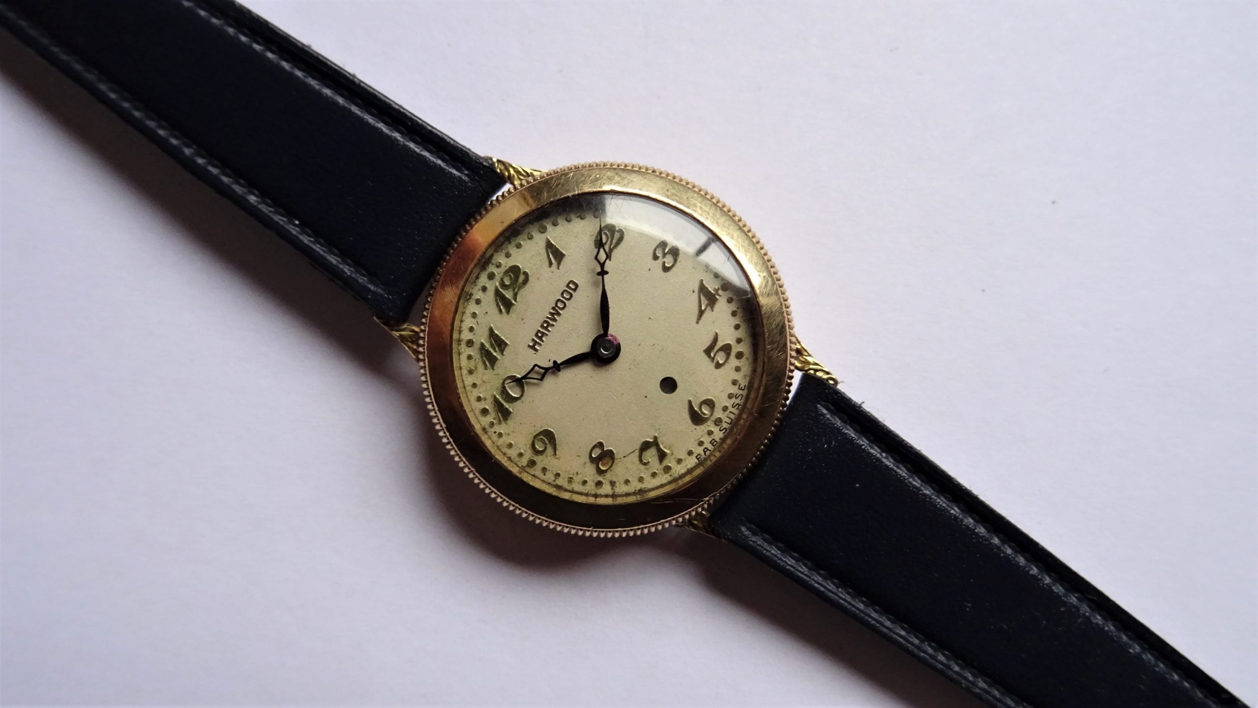 Flatlay of an 18K gold Harwood from the 1920s with an automatic bumper movement