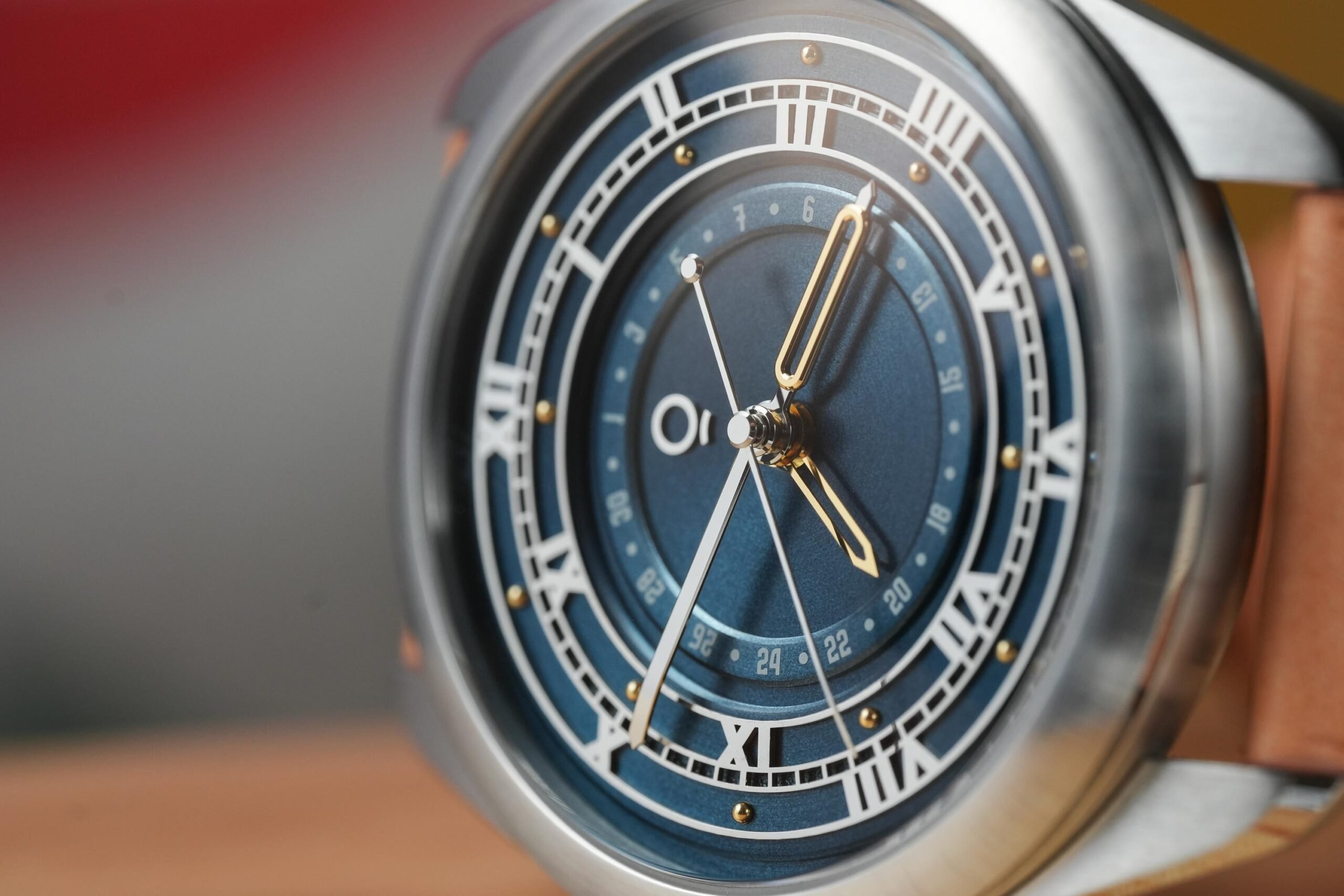 OraOrea Coriolis Pointer Date Venetus teal on its side, close-up of dial