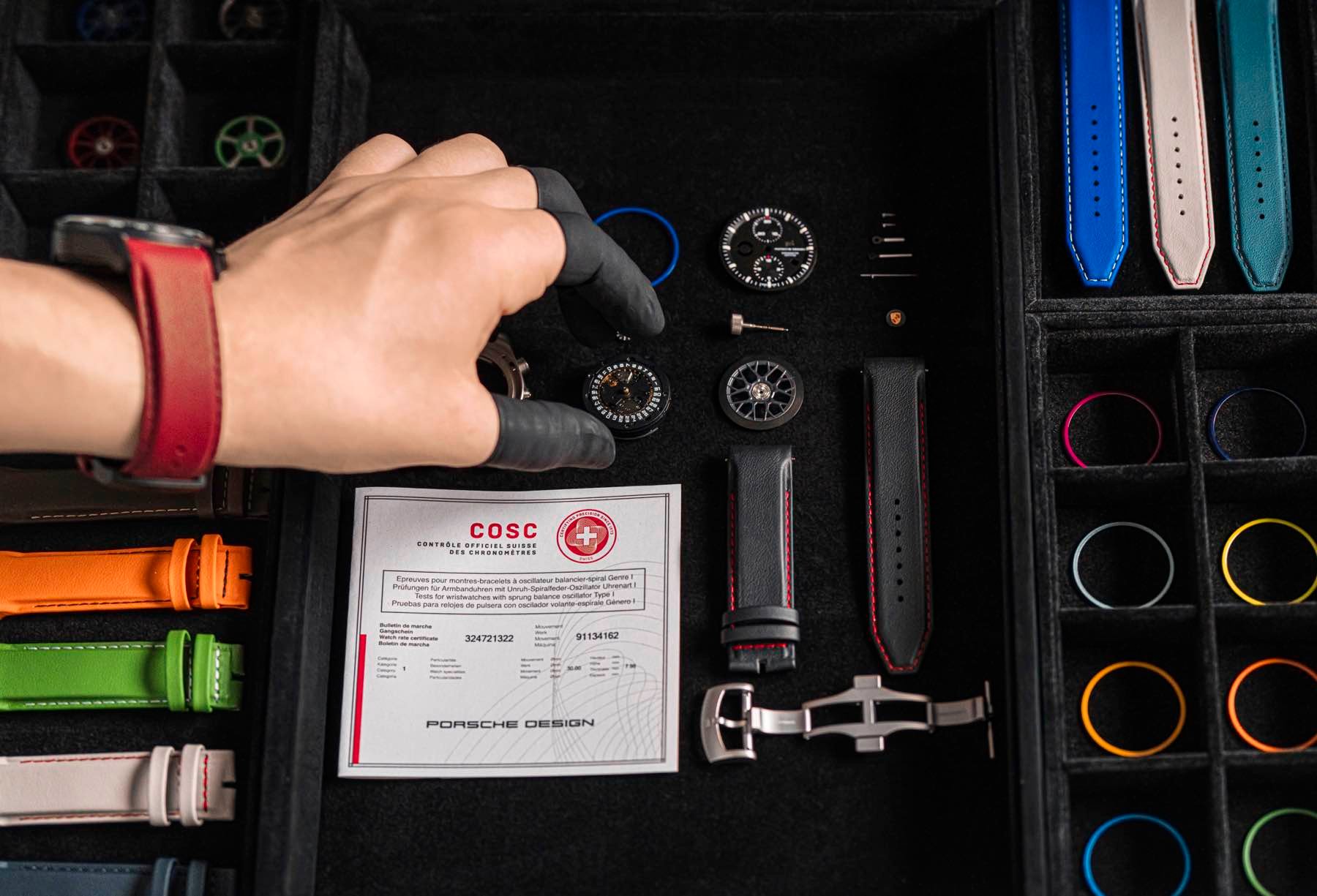 Porsche Design watch disassembled, on display with strap options and COSC chronometer certificate