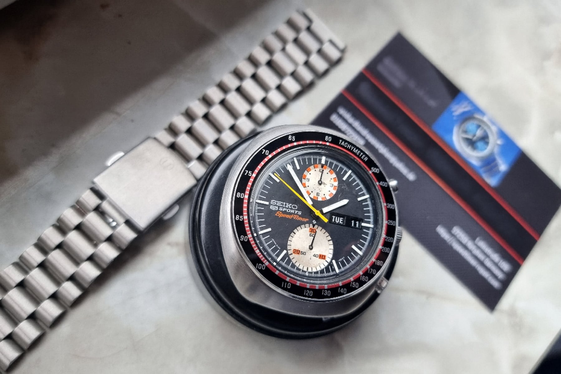 Seiko "UFO" 6138-001X head on cushion and bracelet on table