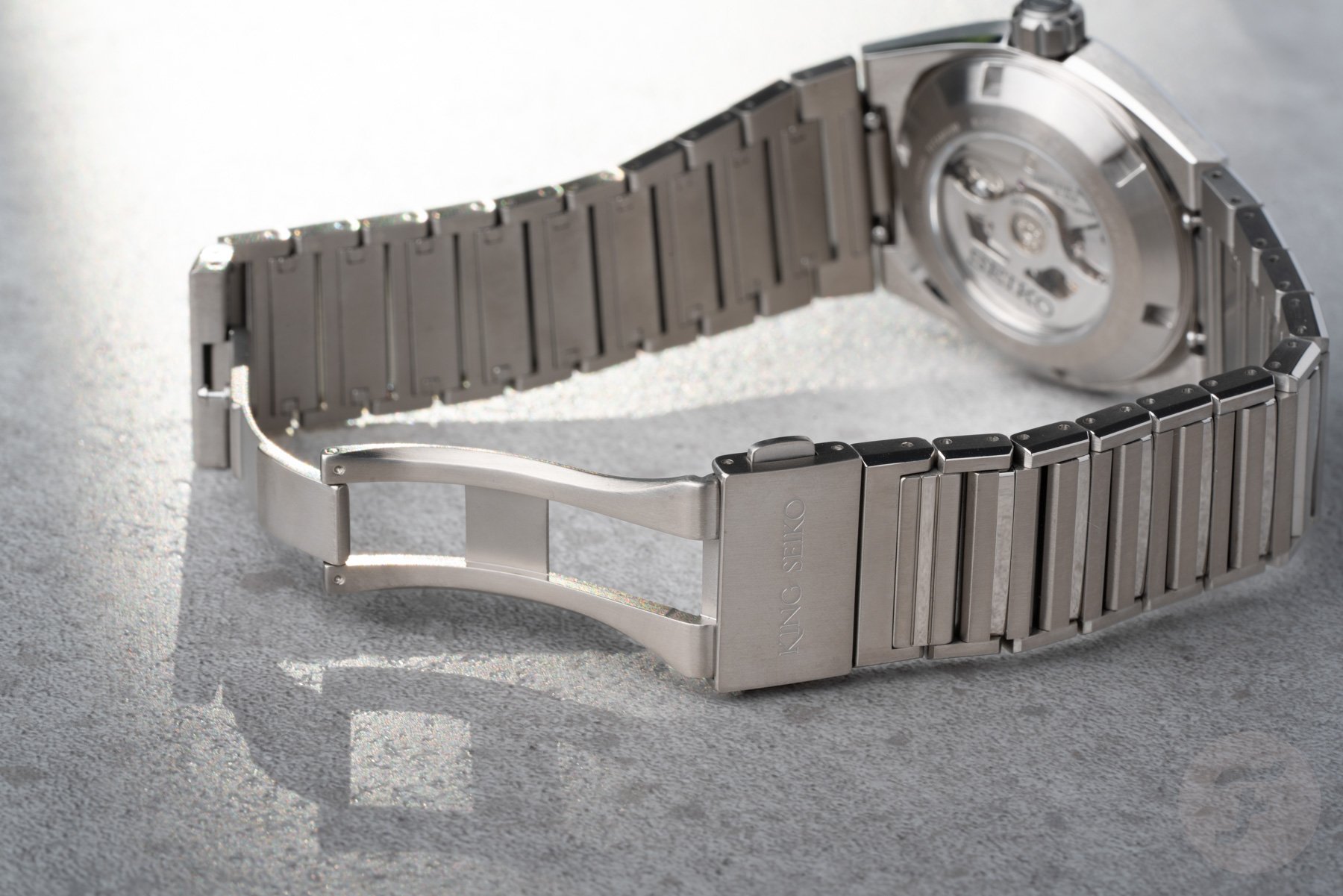 titanium King Seiko Vanac on its side, bracelet clasp open