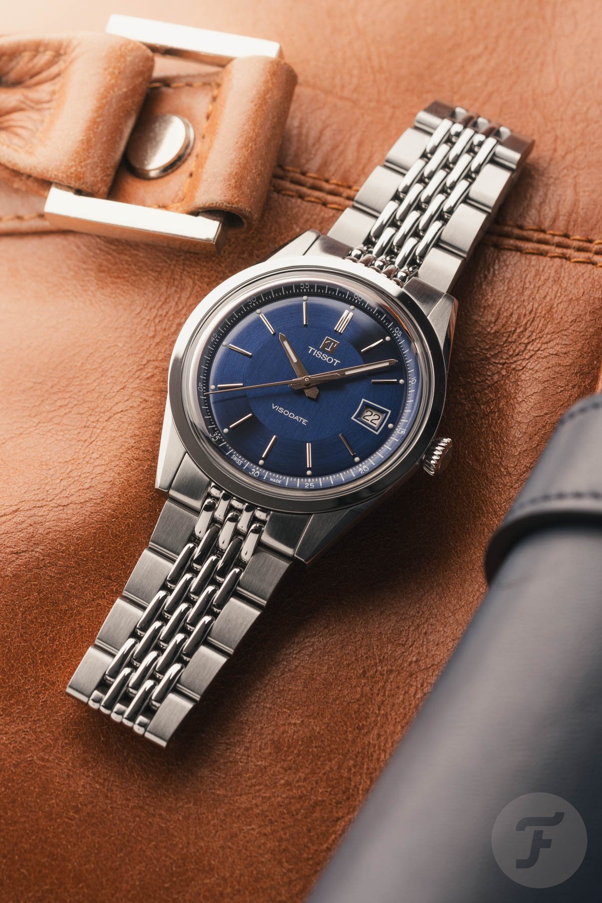 Tissot Visodate flat-lay on brown leather bag