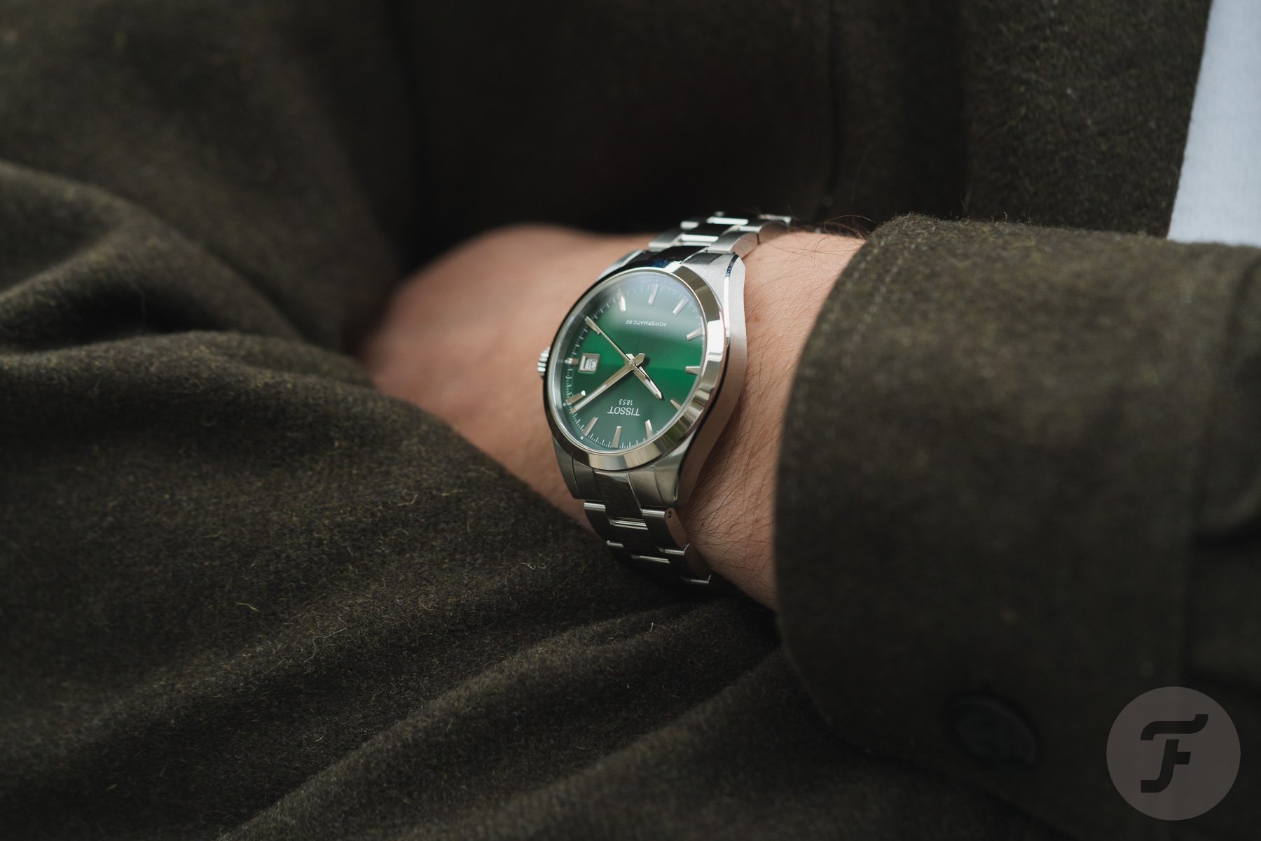 green-dial Tissot Gentleman 38mm on wrist, arms crossed